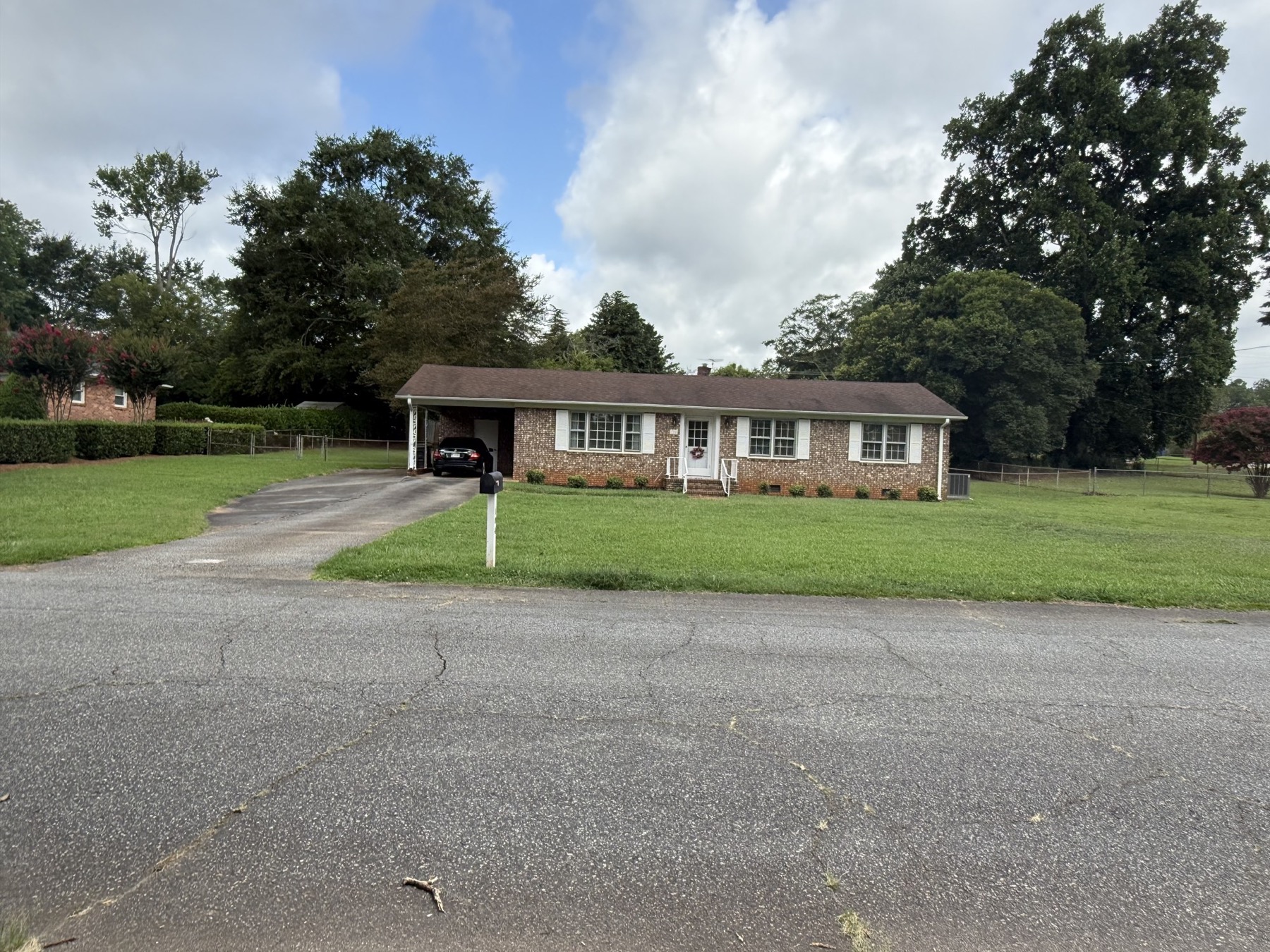 Wide view of the home and front lawn